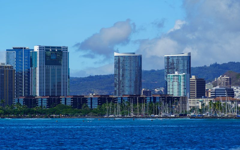 Honolulu skyline rising behind the sailboat masts of the Ala Wai Small Boat Harbor, Oahu