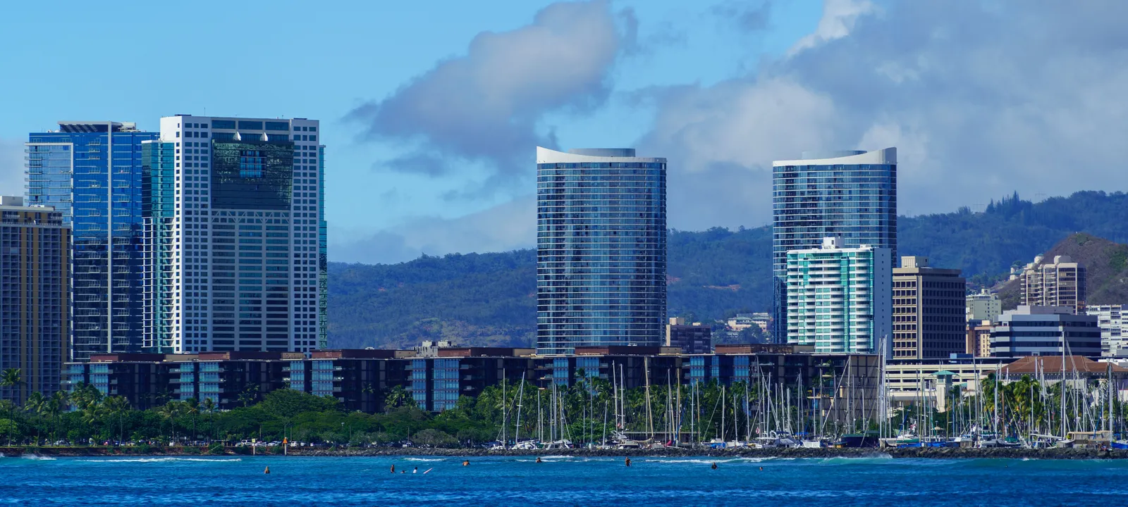 Honolulu skyline rising behind the sailboat masts of the Ala Wai Small Boat Harbor, Oahu