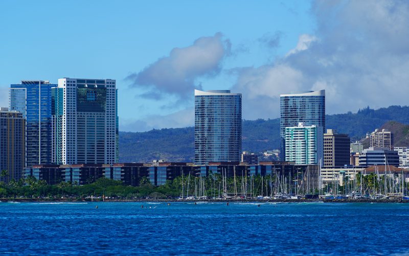 The Honolulu skyline and the Ala Wai boat harbor full of boats seen from the water on Oahu
