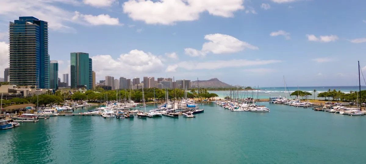 Aerial view of the Honolulu waterfront and a harbor full of boats docked in their slips, Oahu, Hawaii
