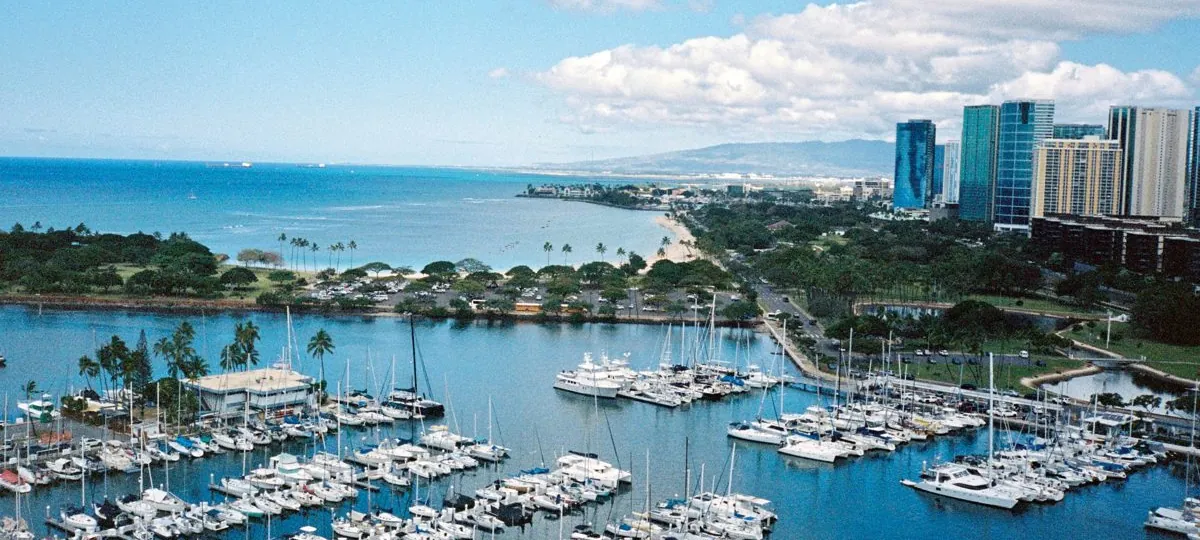 Aerial view of Ala Wai Harbor packed with boats and sailboats, with Waikiki and the Honolulu skyline beyond, Oahu, Hawaii